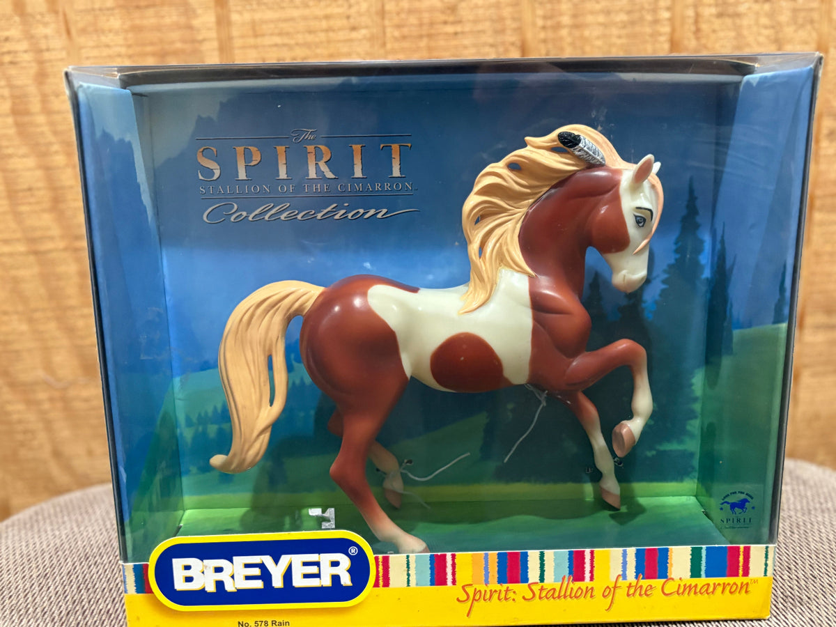 Breyer Spirit of the Cimarron collection toy horse in its original window box packaging, featuring a brown and white pinto horse with a blonde mane and tail.