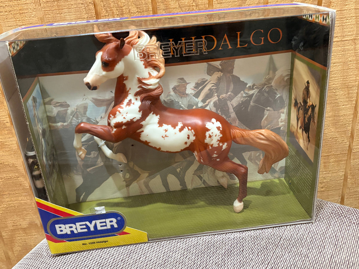 Breyer Hidalgo horse toy in its original retail packaging, displayed against a wooden background.