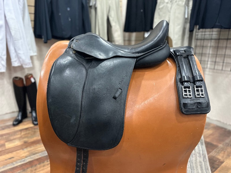 Black leather english dressage saddle pictured on a stand with a black leather girth