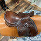 top view of English riding saddle sitting on saddle model with blue and white rug underneath