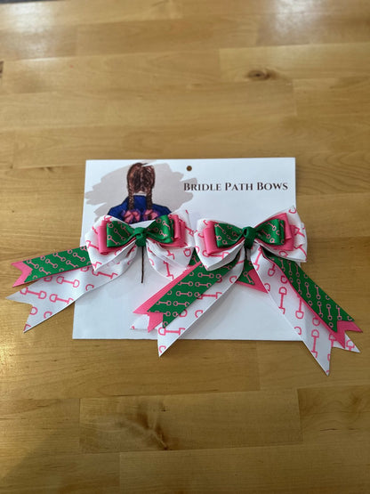 Image of children’s horse riding show bows, green pink and white with pink bit pattern