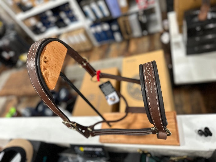 top view of brown leather halter on wood stand