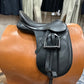 Black leather english saddle showing silver stirrups run up on black stirrup leathers.  Sitting on a tan stand.  