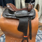 Side view of a two toned leather western saddle with high seat and horn