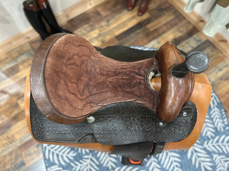 Top view of a western saddle.  Seat is a lighter color leather than the fenders.