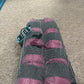 set of two pink equestrian ice boots on brown carpet background