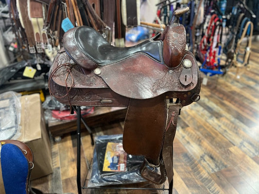 Brown leather western saddle with a black seat