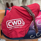 English shaped saddle with a bright red cover showing the CWD logo.