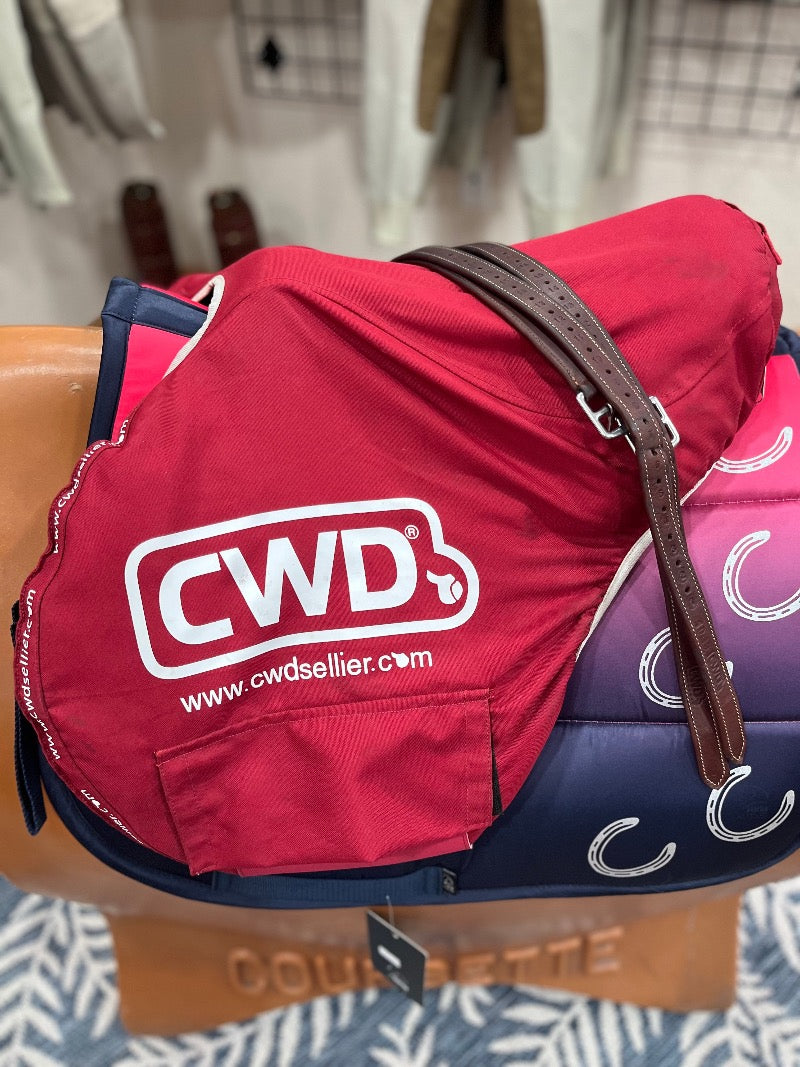 English shaped saddle with a bright red cover showing the CWD logo.