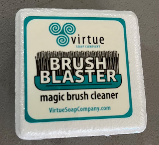 A white square block with label that says Brush Blaster magic brush cleaner