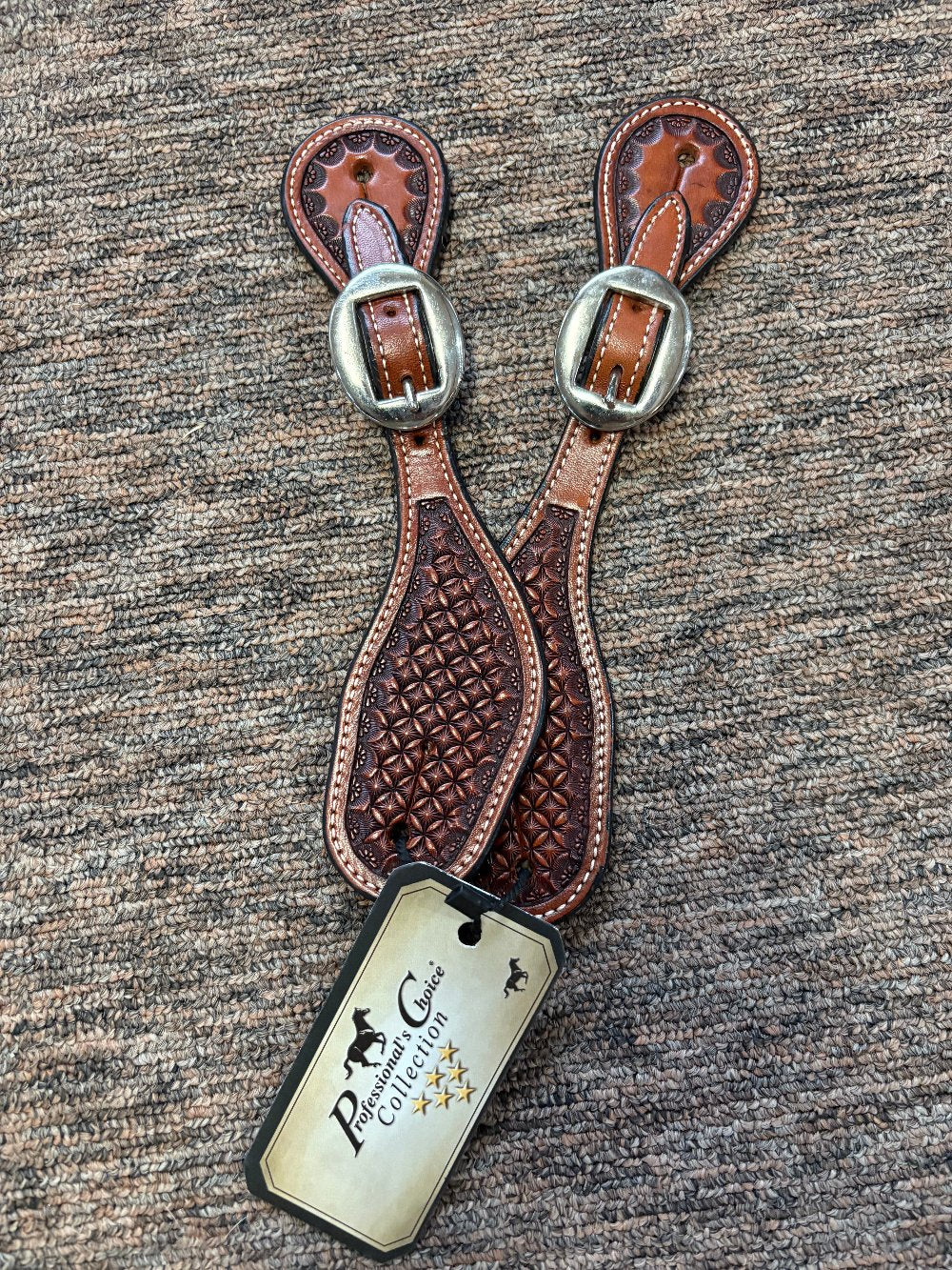 Western style spur straps with a basket weave look in tooled leather