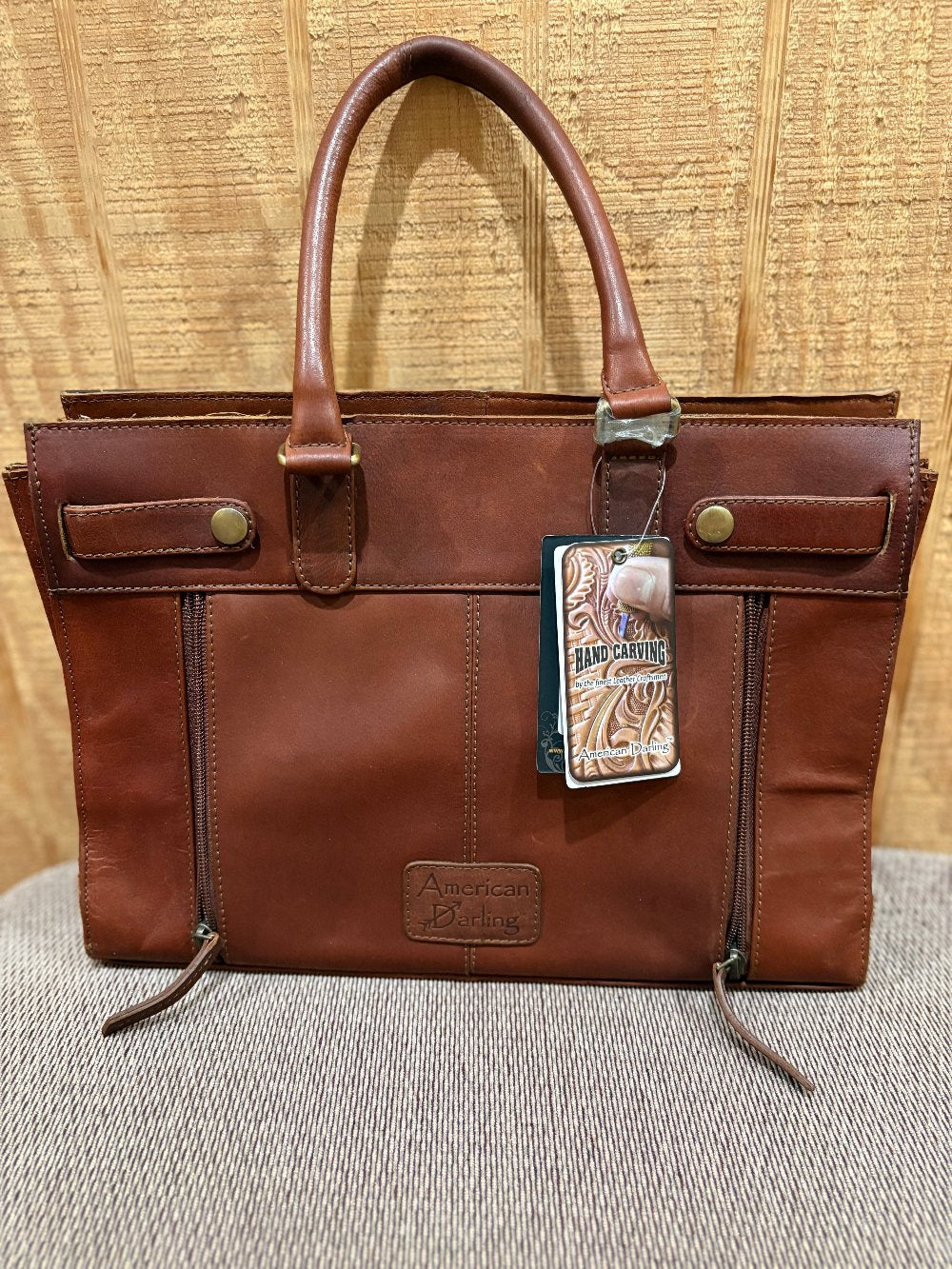 backside of a brown leather ladies handbag showing the conceal and carry compartment