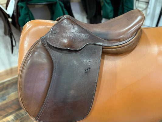 Brown leather english style equestrian saddle with knee rolls.