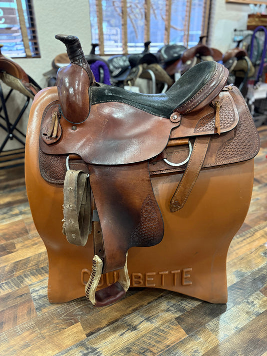 Western style saddle.  Brown leather with black seat.