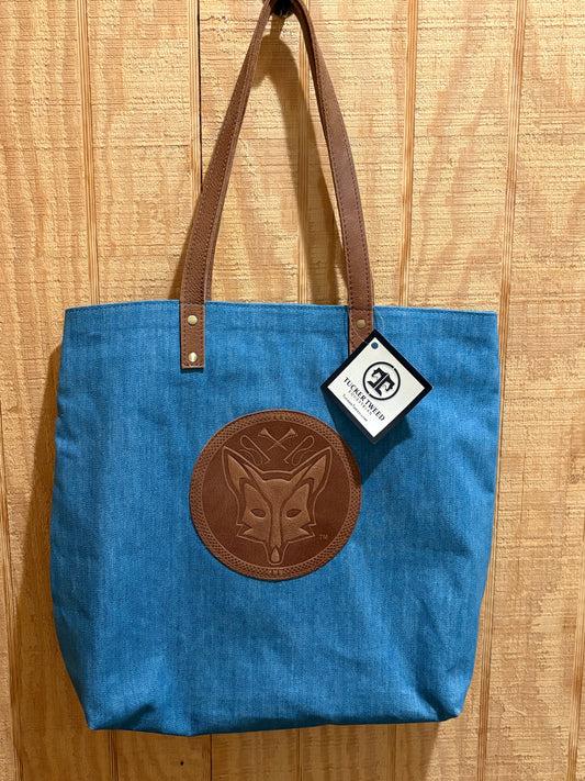 Blue denim tote with leather straps and leather fox embossed on front