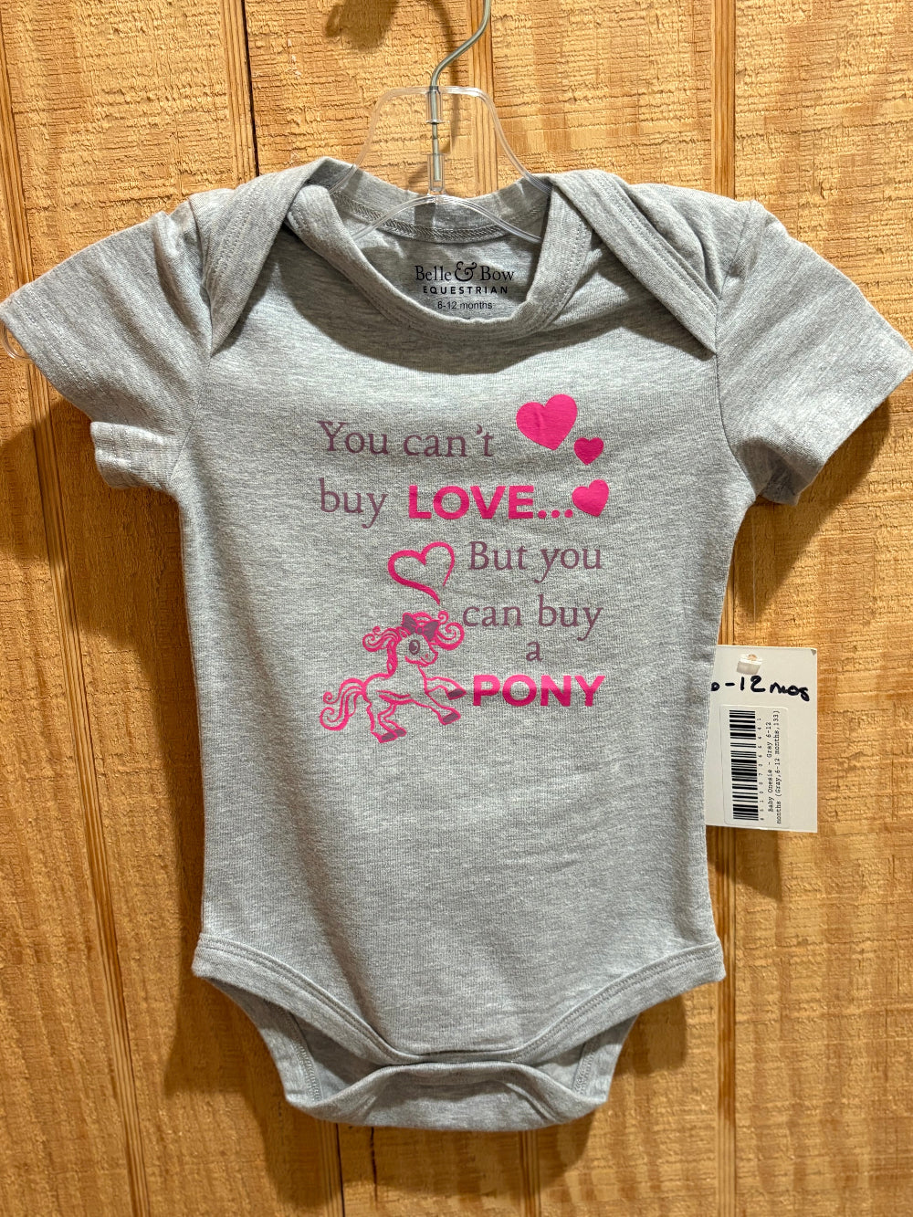 Grey baby onesie with a pony graphic and the words "You can't buy LOVE but you can buy a pony"