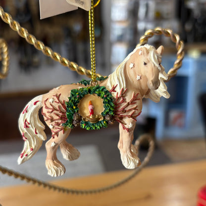 Decorative horse ornament with flowing flaxen mane and feathers hanging on a gold chain.