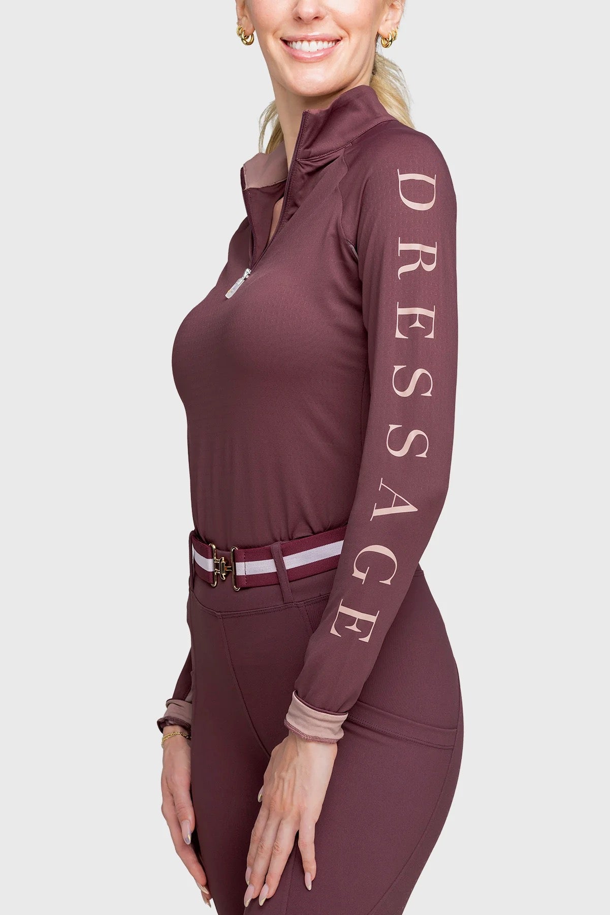 Model wearing long sleeve Cabernet colored quarter zip shirt, with “Dressage” down left arm.