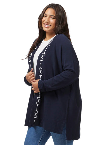 Woman modeling a navy cardigan sweater with a white equestrian Dee Bit design down the front.  below hip length