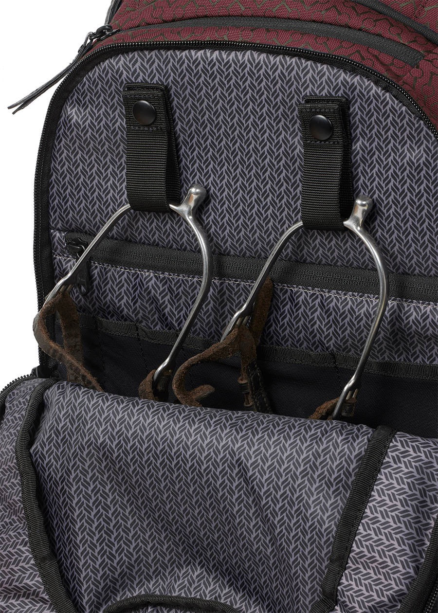 Kerrits equestrian back pack with close up showing how a spurs are stored.