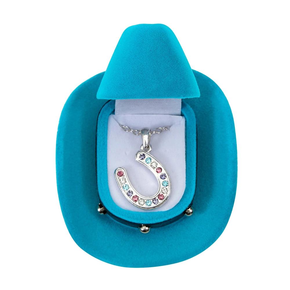 Horseshoe pendant with multiple colored stones shown in a blue cowboy shaped box