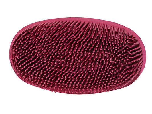 Red rubber grooming face brush with bristles on a white background