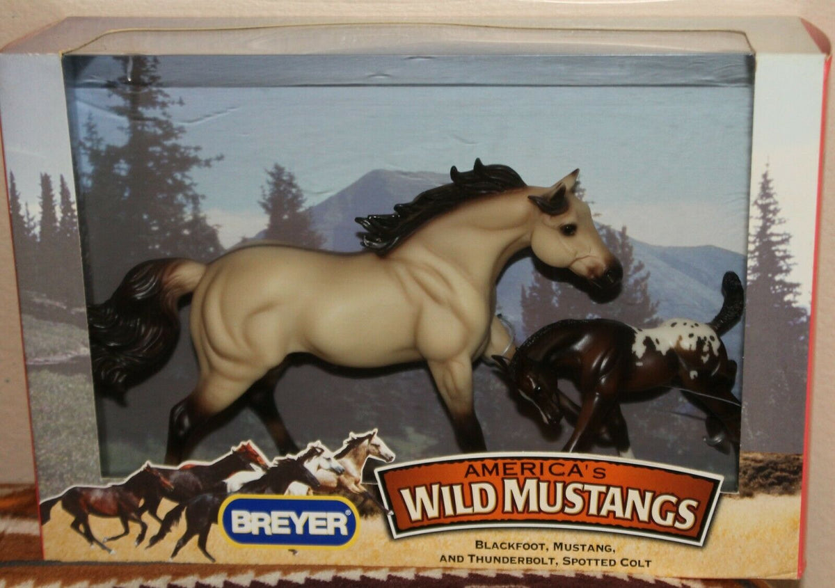 Breyer Wild Mustangs toy horse set in its original retail packaging, featuring a tan mustang and a dark spotted colt against a mountain backdrop.