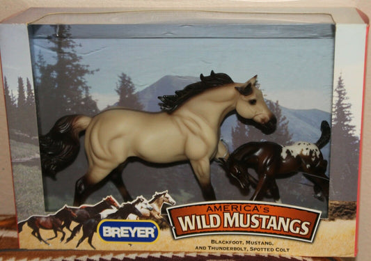 Breyer Wild Mustangs toy horse set in its original retail packaging, featuring a tan mustang and a dark spotted colt against a mountain backdrop.