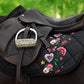saddle with saddle pad underneath on horses back