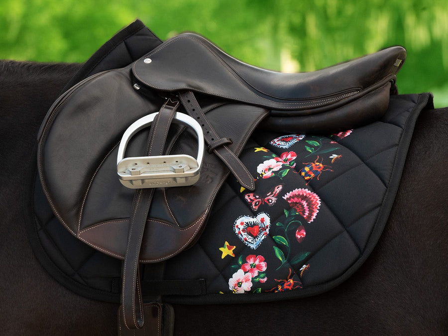 saddle with saddle pad underneath on horses back