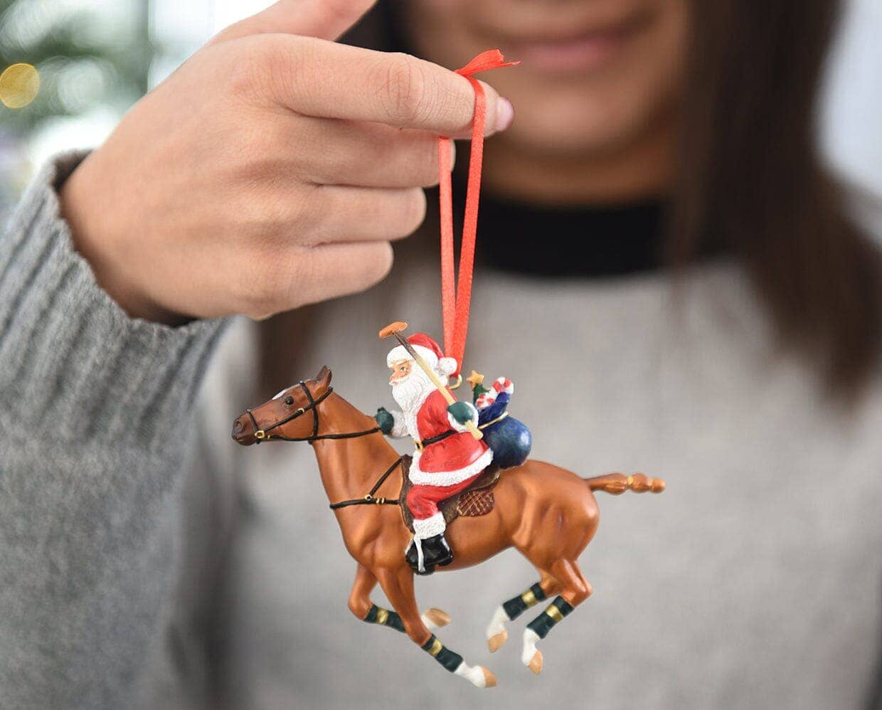 Christmast ornament of santa playing polo on a chestnut horse