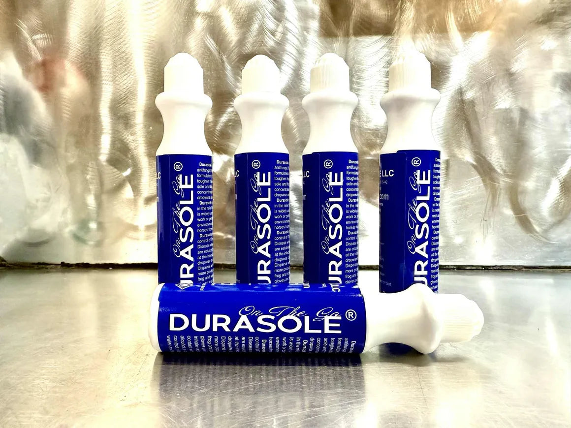 Multiple Durasole On the Go products on a reflective surface with a metallic background