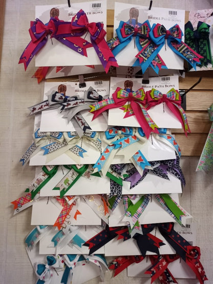 A wall of colorful equestrian show bows