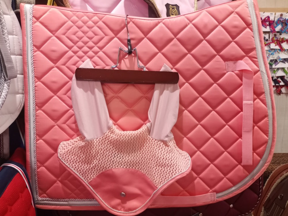 Beautiful coral equestrian saddle pad shown with matching fly bonnet.