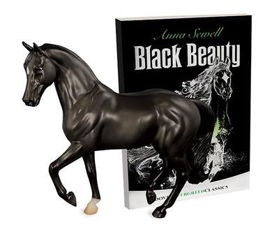 beautiful model of a prancing black horse displayed in front of the book "black beauty"