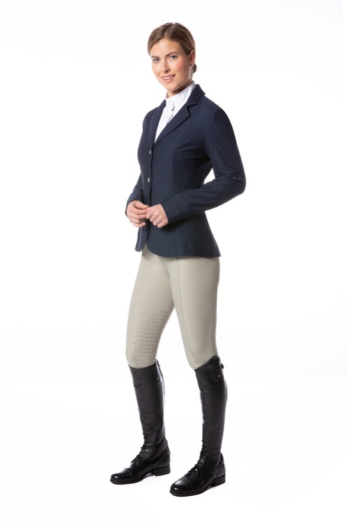 Woman figure modeling an equestrian english style show jacket with tan breeches and black tall boots.