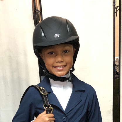 Child model wearing an equestrian english riding helmet with "OV" logo in front