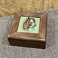 Wooden memory box with raised image of a girl hugging her horse.