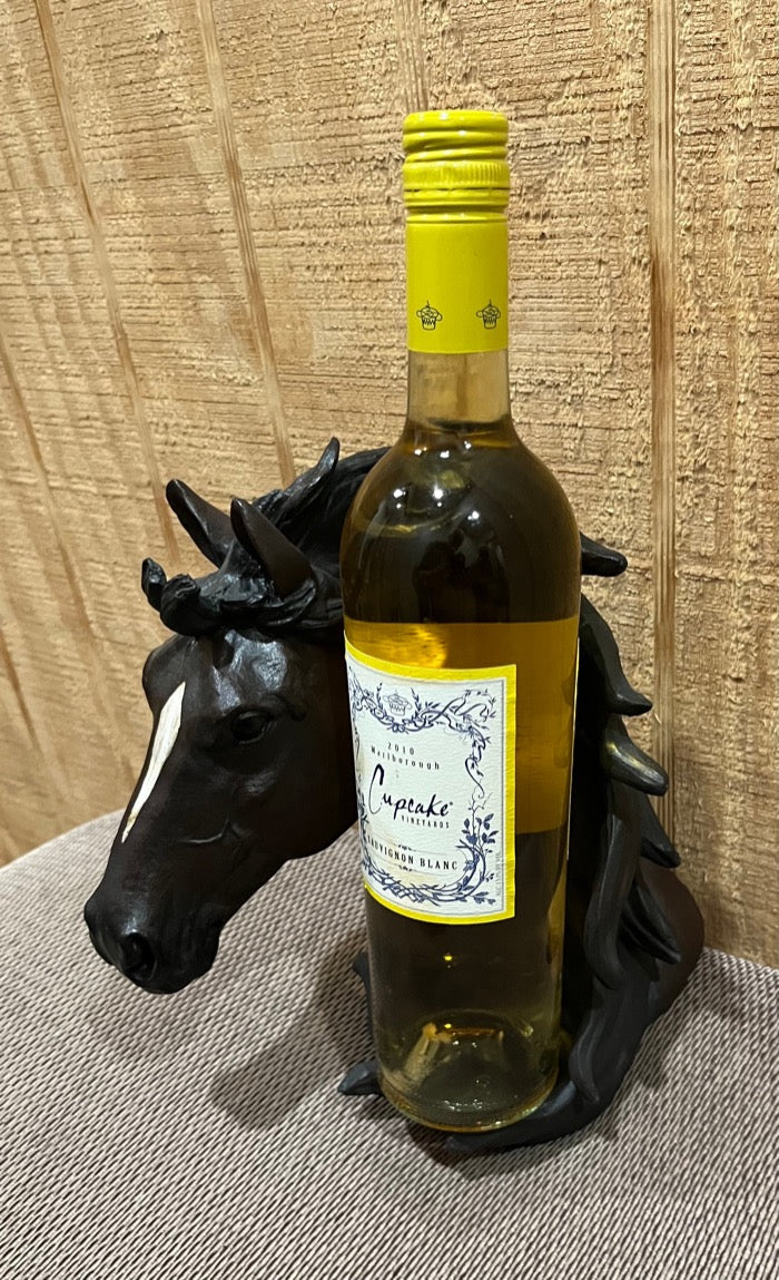 Resin horse head with a white stripe and flowing mane holding a bottle of wine