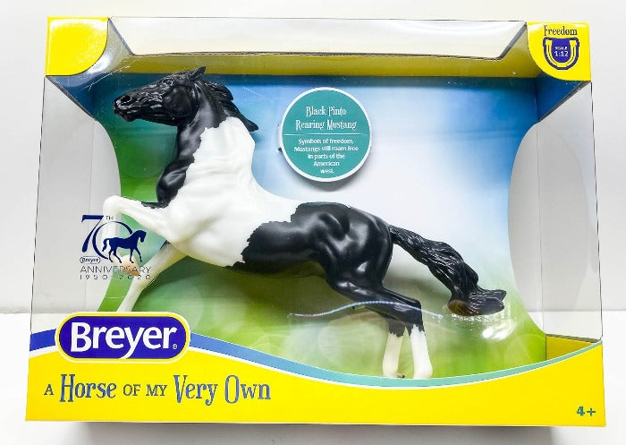 Breyer horse model of Black and white paint mustang in rearing position.